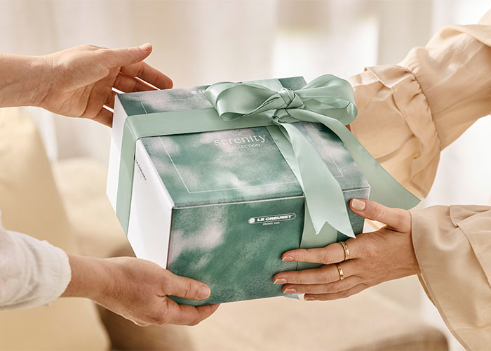 A Serenity Collection gift box tied with a green ribbon