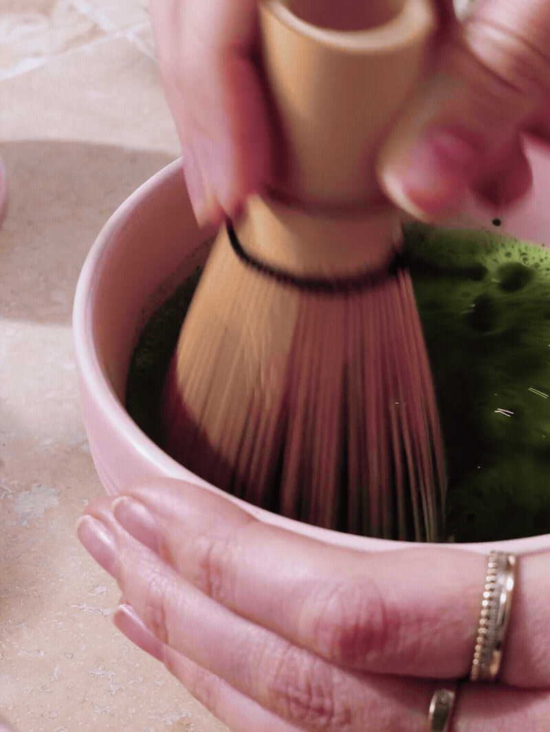 Whisking matcha in a Sugar Pink bowl